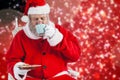 Composite image of santa claus having coffee with cookies Royalty Free Stock Photo