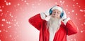 Composite image of santa claus listening to music on headphones with eye closed Royalty Free Stock Photo