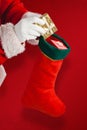 Composite image of santa claus putting presents in christmas stockings Royalty Free Stock Photo