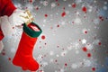 Composite image of santa claus putting presents in christmas stockings Royalty Free Stock Photo