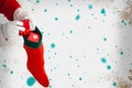 Composite image of santa claus putting presents in christmas stockings Royalty Free Stock Photo