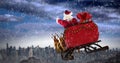 Composite image of santa claus riding on sled with gift box Royalty Free Stock Photo