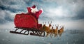 Composite image of santa claus riding on sleigh during christmas