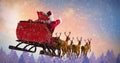 Composite image of santa claus riding on sleigh with gift box Royalty Free Stock Photo