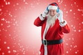 Composite image of santa claus showing hand okay sign while listening to music on headphones Royalty Free Stock Photo