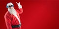 Composite image of santa claus showing hand yo sign while listening to music on headphones Royalty Free Stock Photo