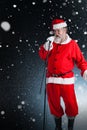 Composite image of santa claus singing christmas songs Royalty Free Stock Photo