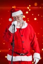 Composite image of santa claus singing songs against white background Royalty Free Stock Photo