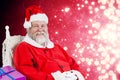 Composite image of santa claus sitting on chair with sack of christmas presents Royalty Free Stock Photo