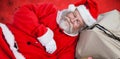 Composite image of santa claus sleeping beside christmas presents Royalty Free Stock Photo