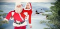 Composite image of santa and mrs claus smiling at camera Royalty Free Stock Photo