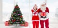 Composite image of santa and mrs claus smiling at camera offering gift Royalty Free Stock Photo