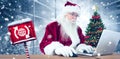 Composite image of santa surfs on the internet Royalty Free Stock Photo