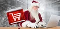 Composite image of santa surfs on the internet Royalty Free Stock Photo