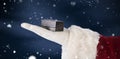 Composite image of santas hand shows a small box