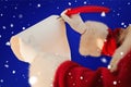 Composite image of santas hand writing list with a quill Royalty Free Stock Photo