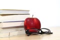 Composite image of school supplies on desk, Apple, books and glasses on the desktop