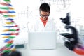 Composite image of schoolboy using laptop at desk Royalty Free Stock Photo