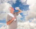Composite image of senior man drinking from water bottle Royalty Free Stock Photo
