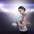 Composite image of serious muscular woman lifting kettlebell Royalty Free Stock Photo