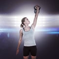 Composite image of serious muscular woman lifting kettlebell Royalty Free Stock Photo