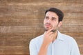 Composite image of serious thinking man looking up