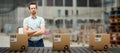 Composite image of serious warehouse manager standing with arms crossed Royalty Free Stock Photo