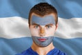 Composite image of serious young argentina fan with facepaint Royalty Free Stock Photo