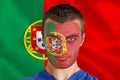 Composite image of serious young portugal fan with facepaint