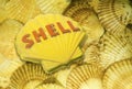 Composite image of Shell oil company sign over a bed of seashells