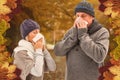 Composite image of sick mature couple blowing their noses Royalty Free Stock Photo