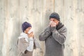 Composite image of sick mature couple blowing their noses Royalty Free Stock Photo