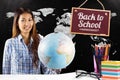 Composite image of smiling asian woman holding a globe Royalty Free Stock Photo