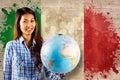 Composite image of smiling asian woman holding a globe Royalty Free Stock Photo