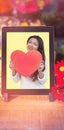 Composite image of smiling asian woman holding paper heart Royalty Free Stock Photo