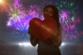 Composite image of smiling asian woman holding paper heart Royalty Free Stock Photo