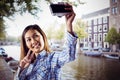 Composite image of smiling asian woman taking picture with camera Royalty Free Stock Photo