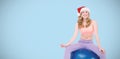 Composite image of smiling blonde woman sitting on exercise ball Royalty Free Stock Photo