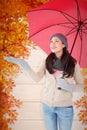 Composite image of smiling brunette feeling the rain Royalty Free Stock Photo