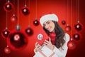 Composite image of smiling brunette holding christmas gifts Royalty Free Stock Photo