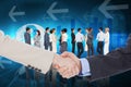 Composite image of smiling business people shaking hands while looking at the camera Royalty Free Stock Photo