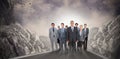Composite image of smiling business team looking at camera Royalty Free Stock Photo
