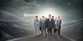 Composite image of smiling business team looking at camera Royalty Free Stock Photo