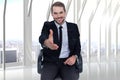 Composite image of smiling businessman on an chair office offering handshake Royalty Free Stock Photo