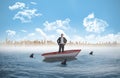 Composite image of smiling businessman with hands on hips in a sailboat