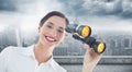 Composite image of smiling businesswoman with binoculars Royalty Free Stock Photo