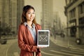 Composite image of smiling businesswoman showing a tablet Royalty Free Stock Photo