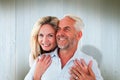 Composite image of smiling couple embracing with woman looking at camera Royalty Free Stock Photo