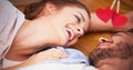 Composite image of smiling couple lying on the floor Royalty Free Stock Photo