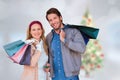 Composite image of smiling couple with shopping bags in front of window Royalty Free Stock Photo
